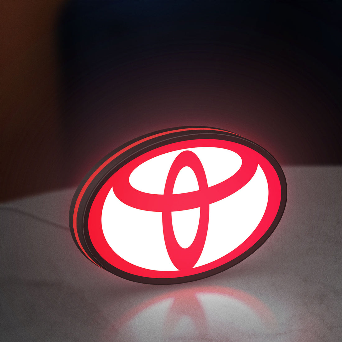 Toyota LED lightbox hanging on a wall with red glow