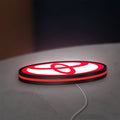 Toyota LED lightbox lying flat on a desk with red glow
