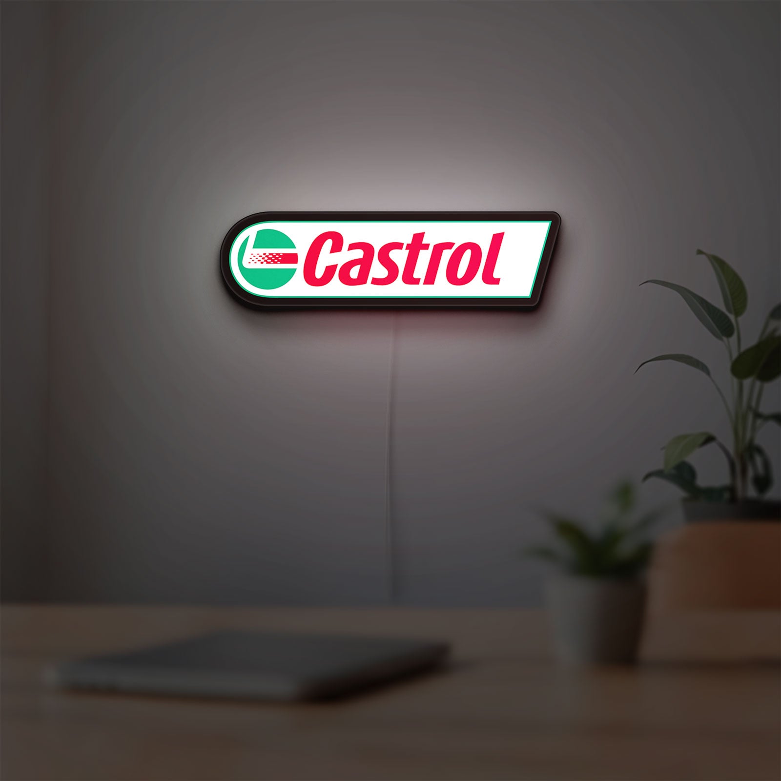 Castrol LED lightbox hanging on a room wall with soft white light