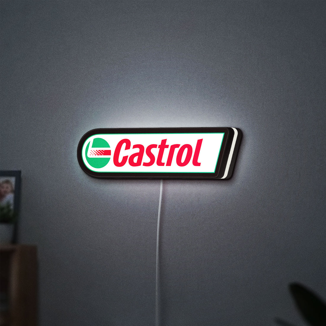 Castrol LED lightbox hanging on a wall with white glow