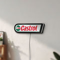 Unlit Castrol LED lightbox mounted on a wall in daylight