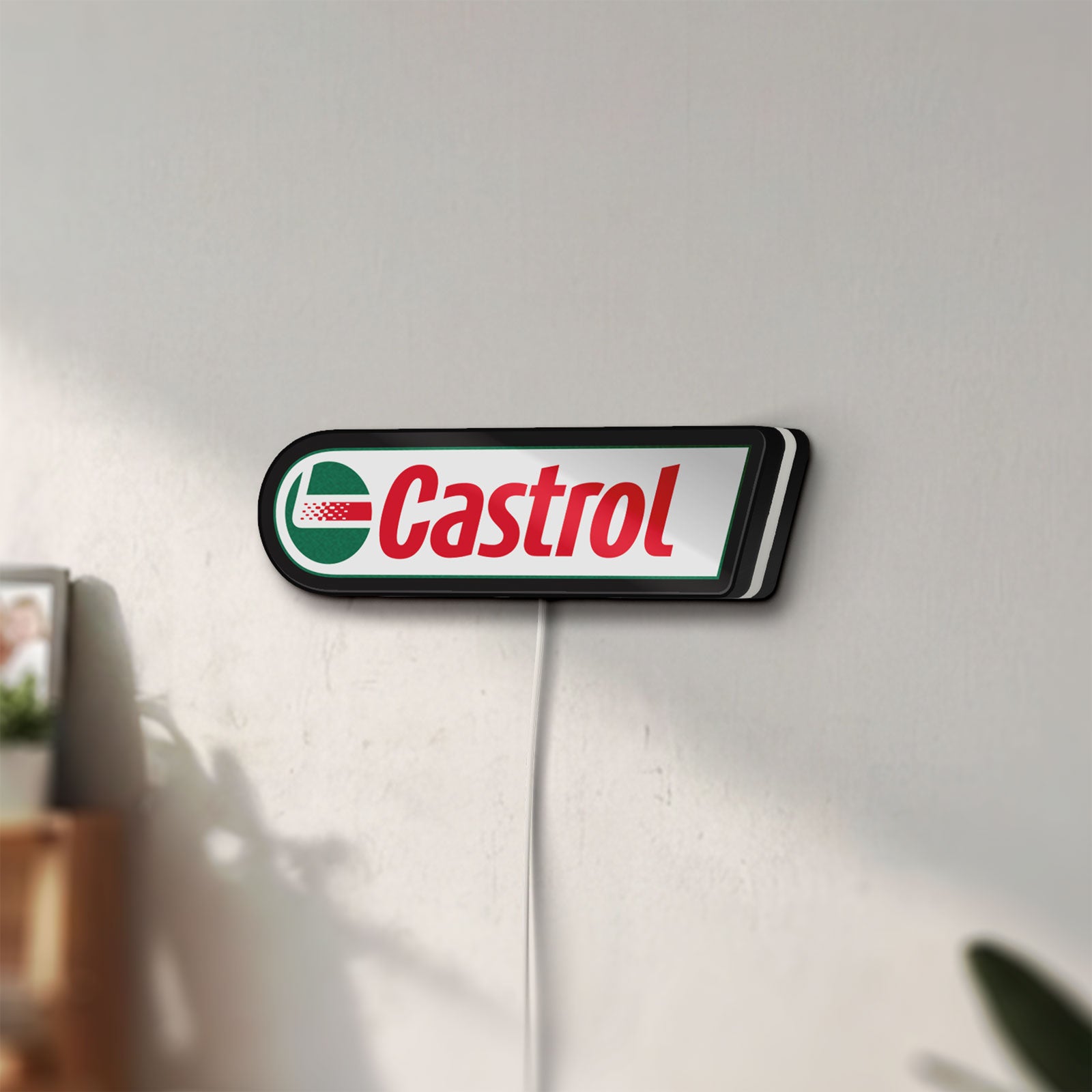 Unlit Castrol LED lightbox mounted on a wall in daylight