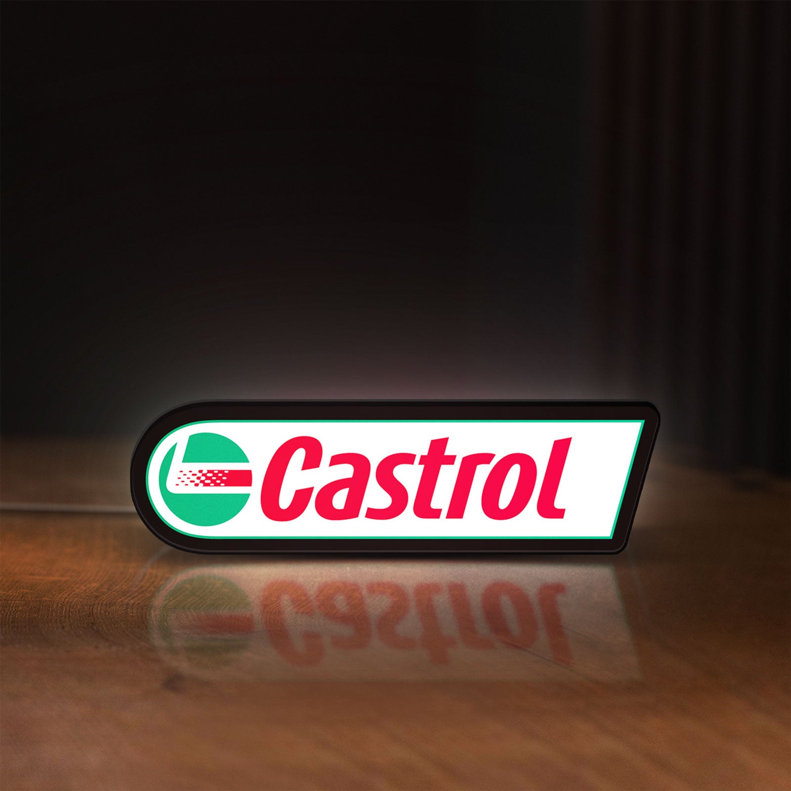 Front view of Castrol LED lightbox sign glowing on a wooden desk