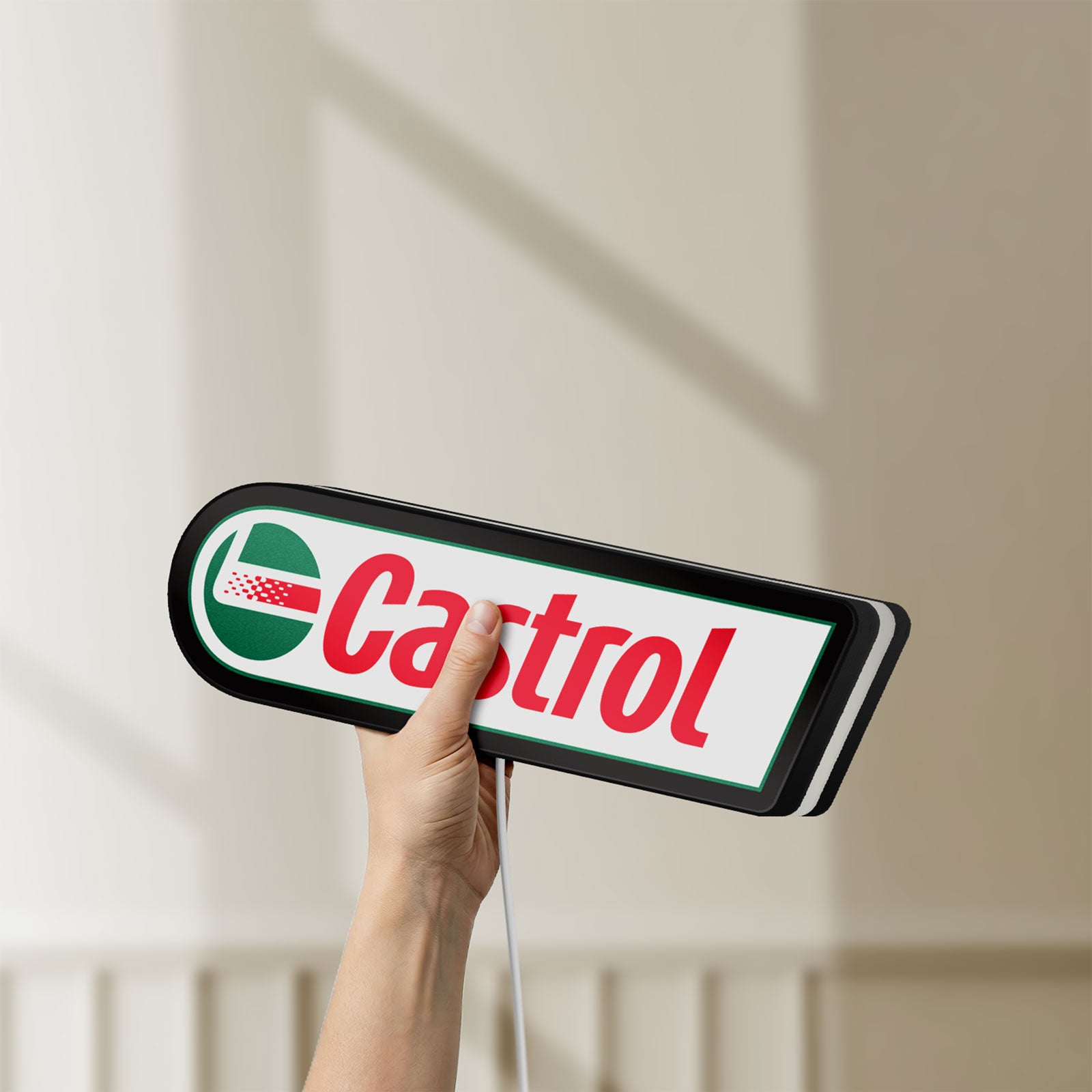 Unlit Castrol LED lightbox held by hand to show size and details