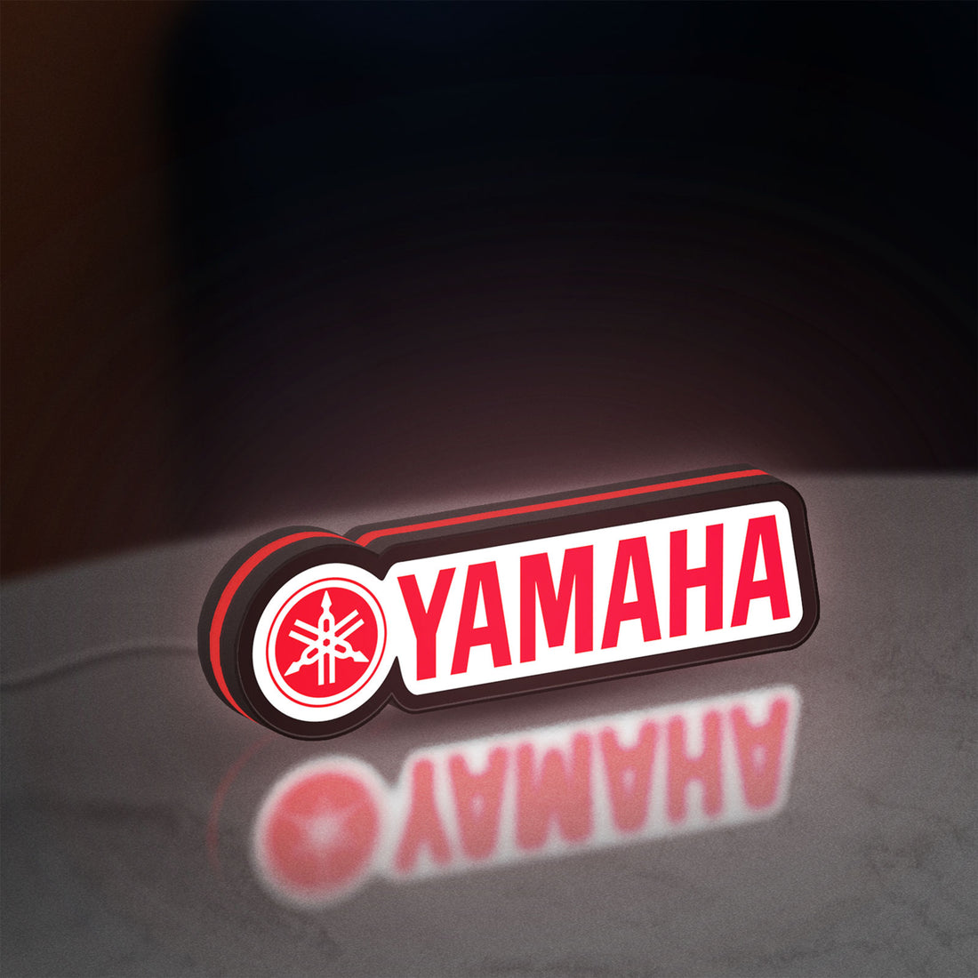 Yamaha LED lightbox hanging on a wall with red glow