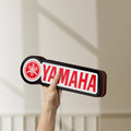 Unlit Yamaha LED lightbox held by hand to show size and details