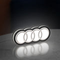 Audi LED lightbox standing on a desk from an angled side view with white glow