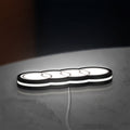 Audi LED lightbox lying flat on a desk with white glow