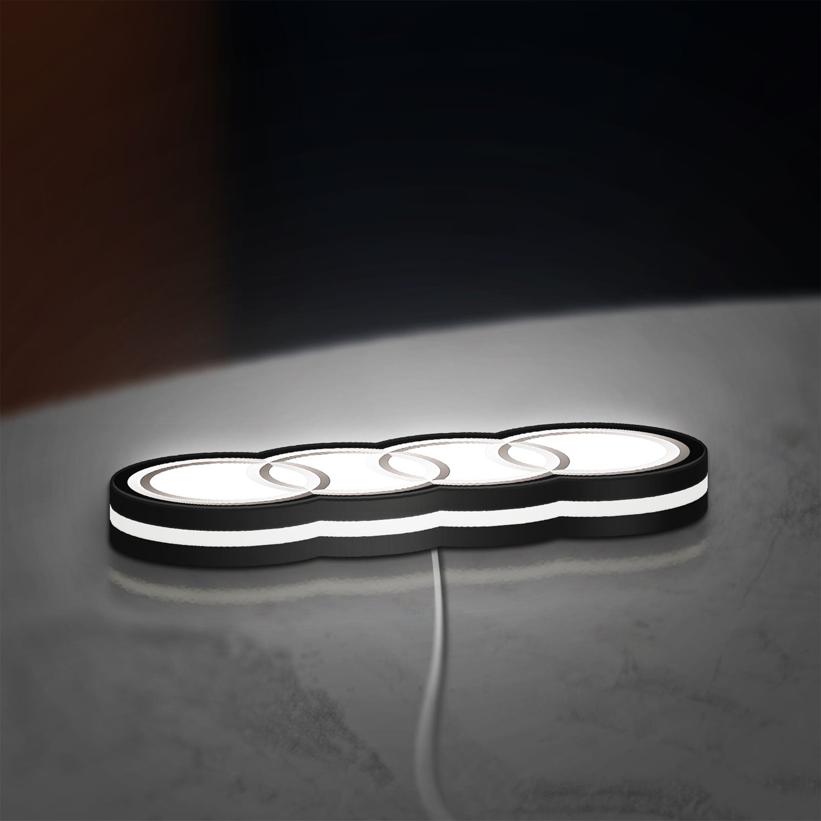 Audi LED lightbox lying flat on a desk with white glow