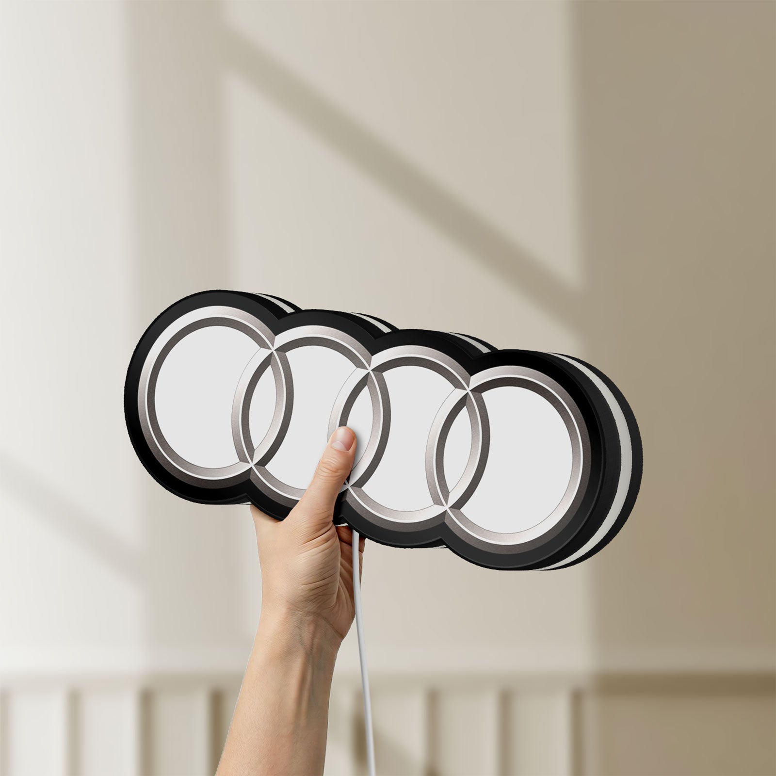 Unlit Audi LED lightbox held by hand to show size and details