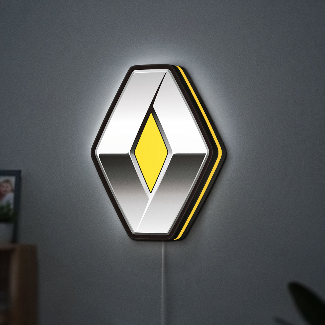Renault LED lightbox hanging on a wall with yellow glow