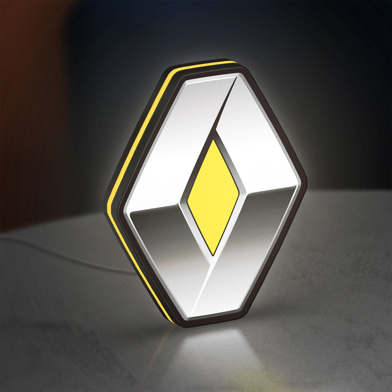 Renault LED lightbox standing on a desk from an angled side view with yellow glow