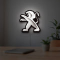 Peugeot LED lightbox hanging on a room wall with soft white light