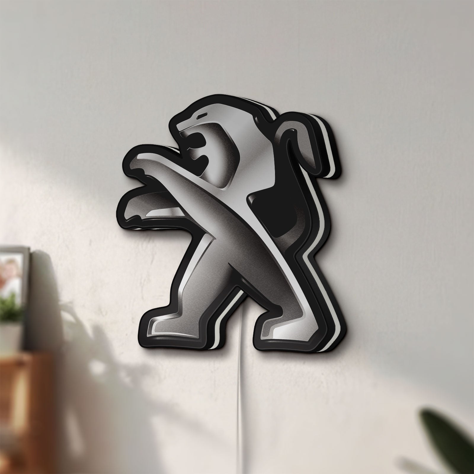 Unlit Peugeot LED lightbox mounted on a wall in daylight