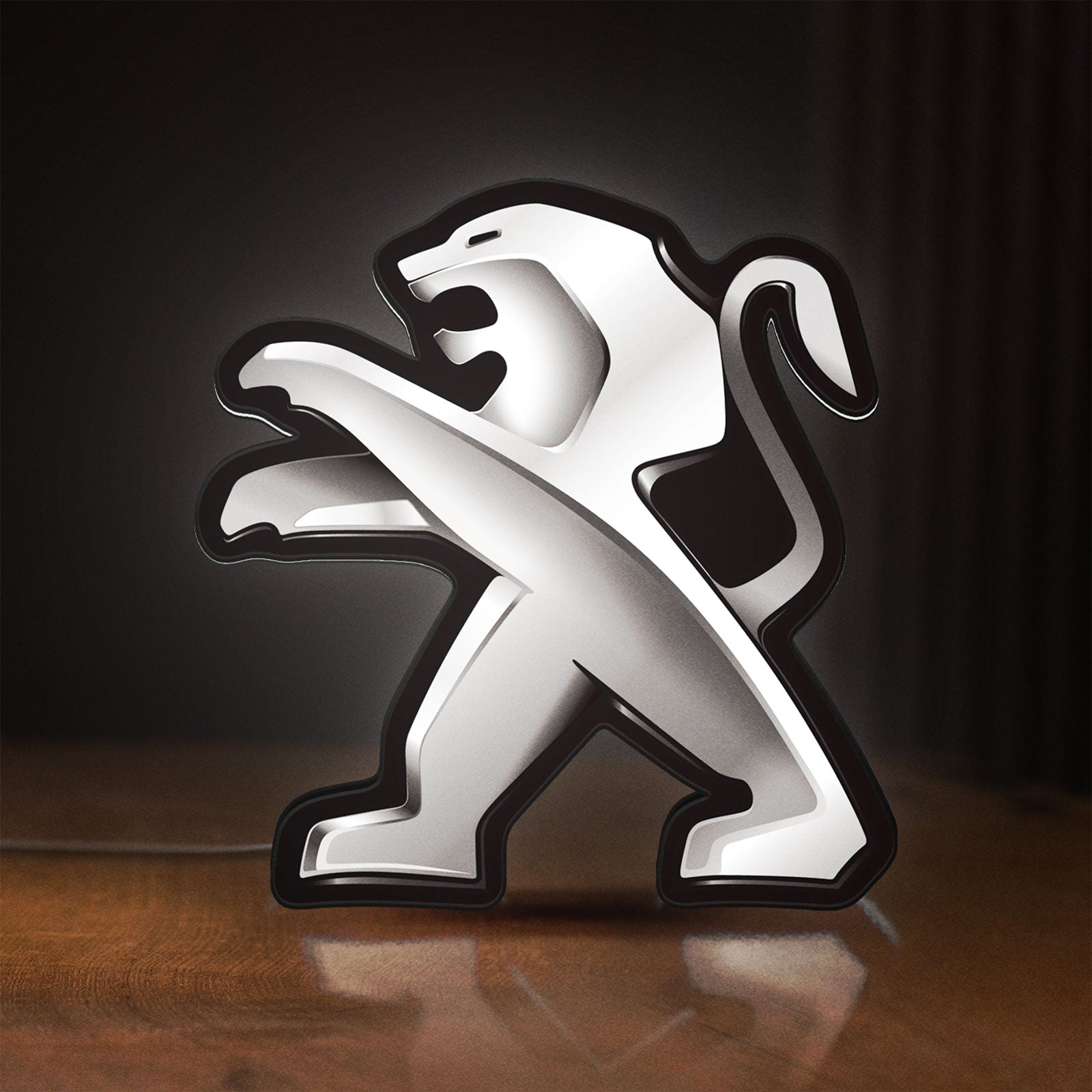 Front view of Peugeot LED lightbox sign glowing on a wooden desk