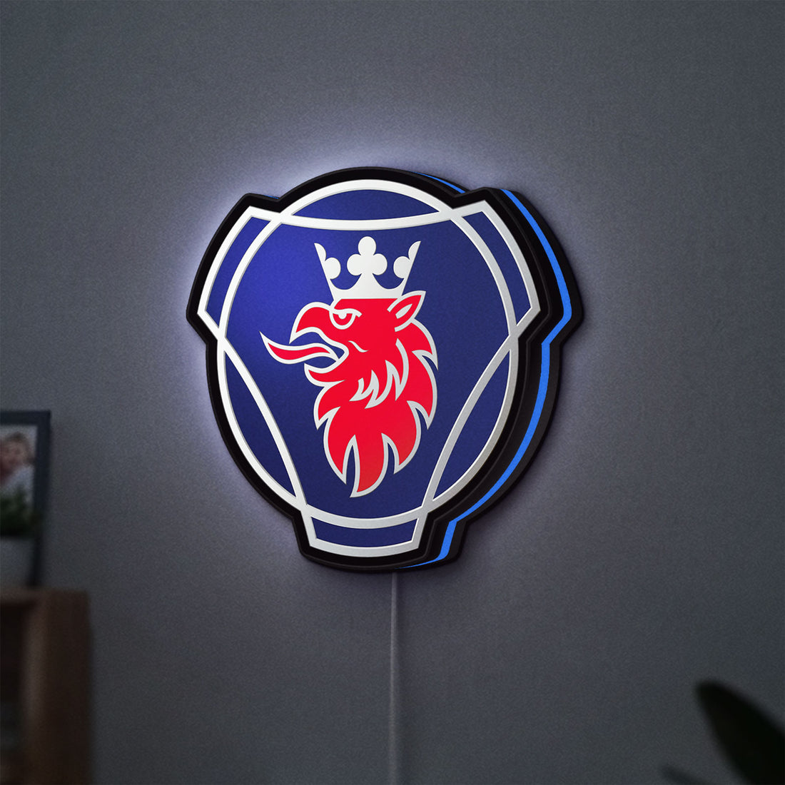 Scania Griffin LED lightbox hanging on a wall with blue glow
