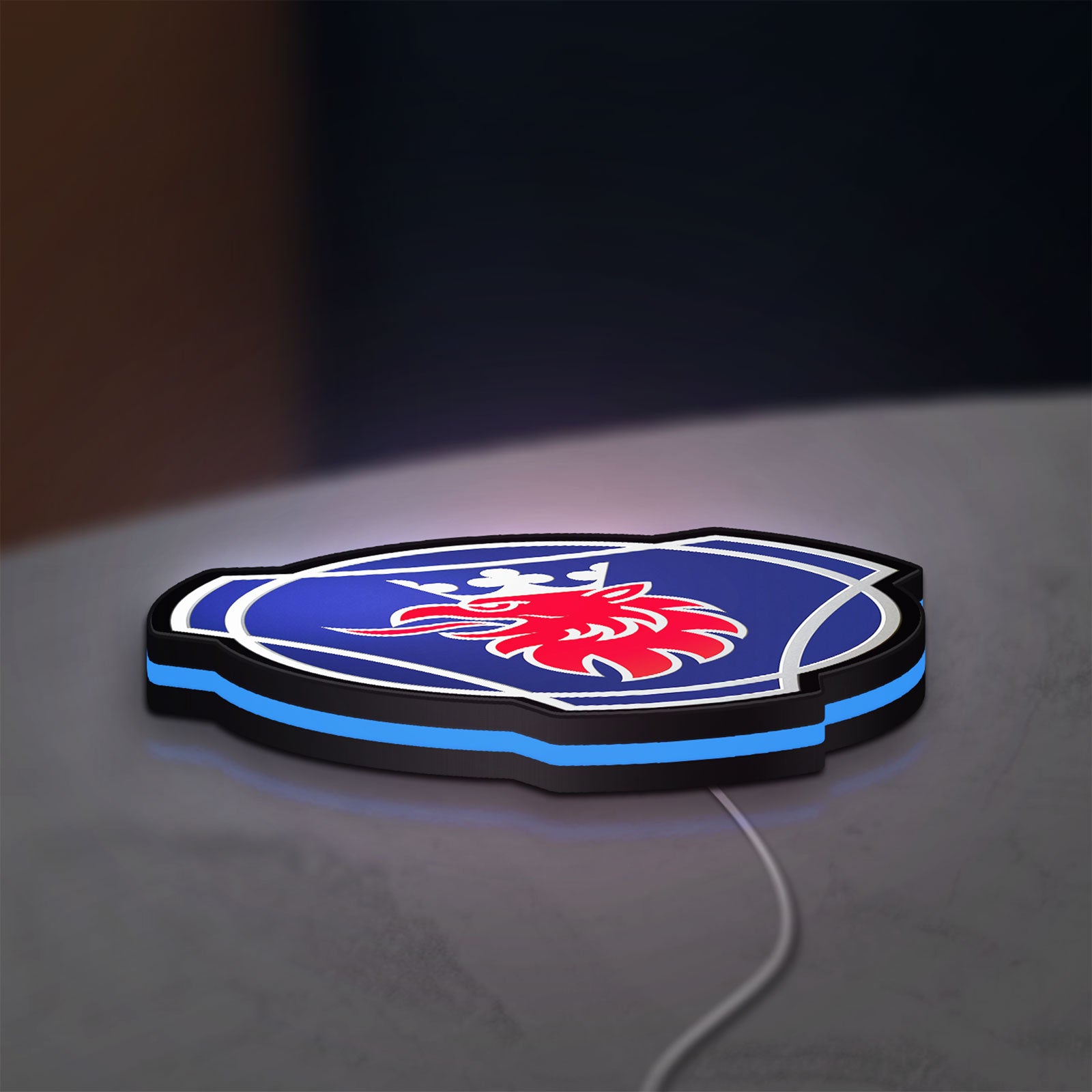 Scania Griffin LED lightbox lying flat on a desk with blue glow