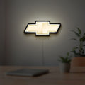 Chevrolet LED lightbox hanging on a room wall with soft white light
