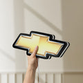 Unlit Chevrolet LED lightbox held by hand to show size and details