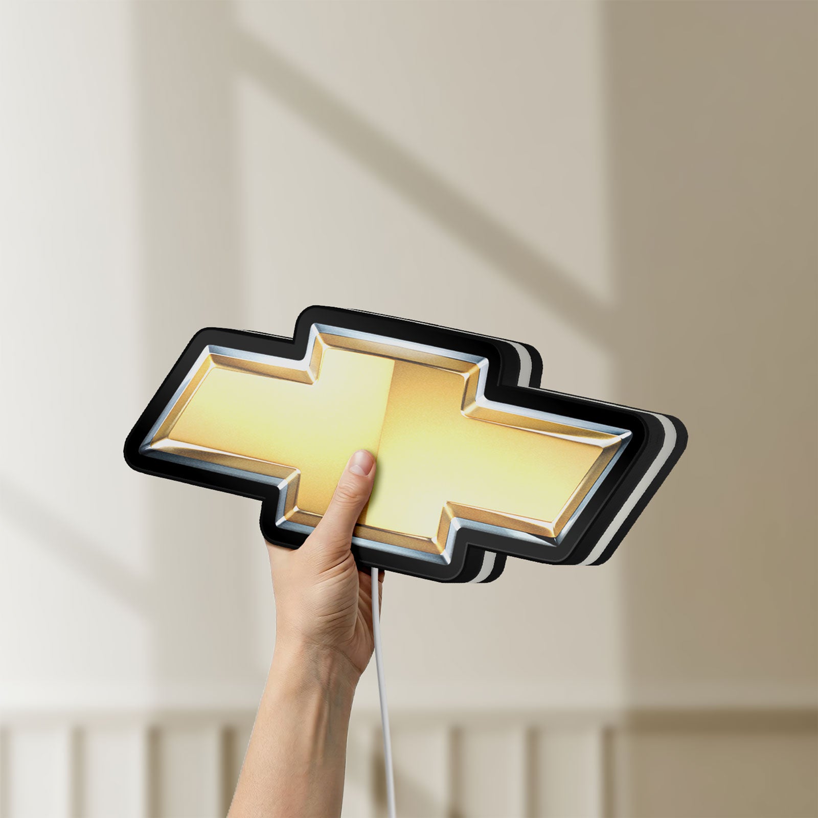 Unlit Chevrolet LED lightbox held by hand to show size and details
