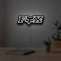Fox Logo LED lightbox hanging on a room wall with soft white light
