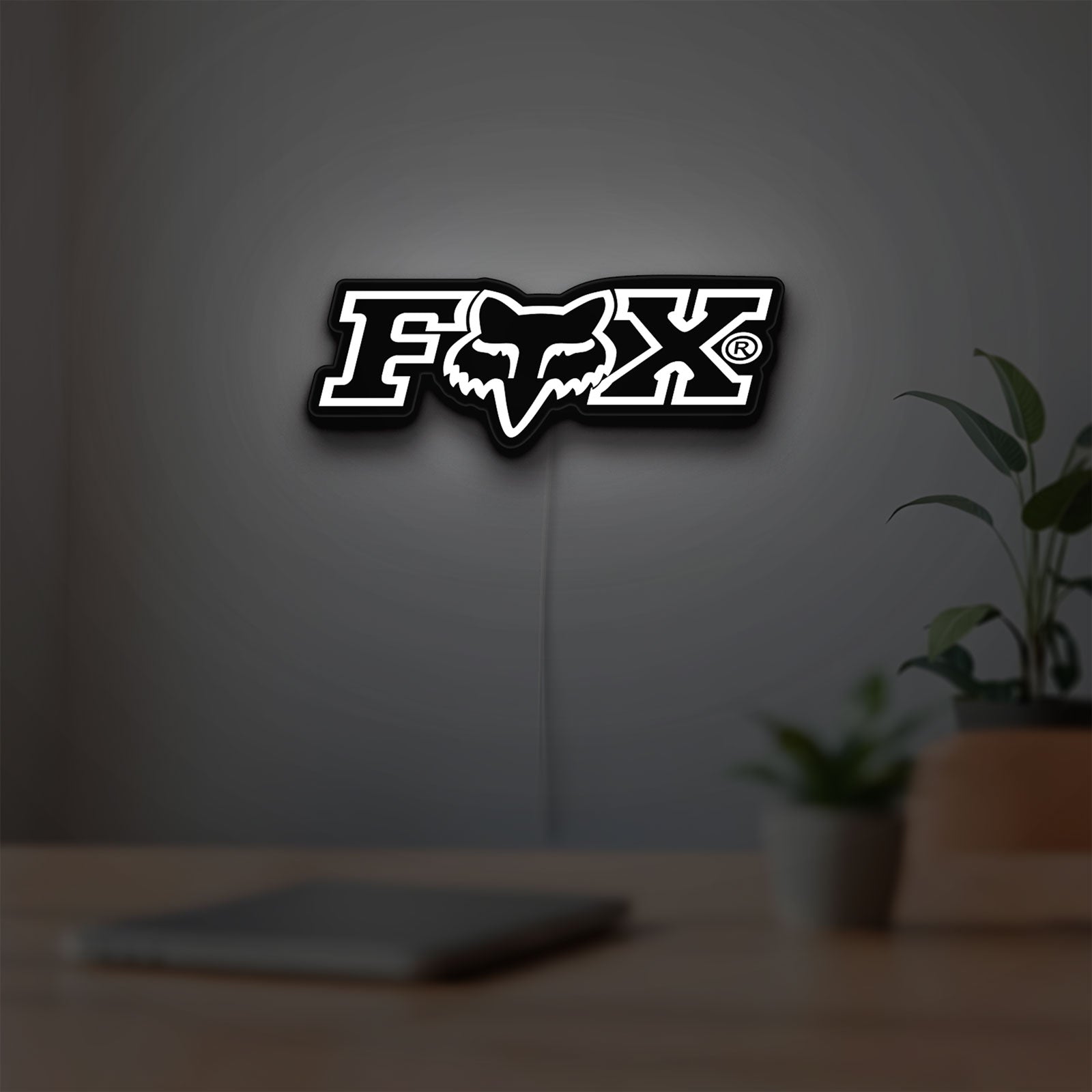 Fox Logo LED lightbox hanging on a room wall with soft white light