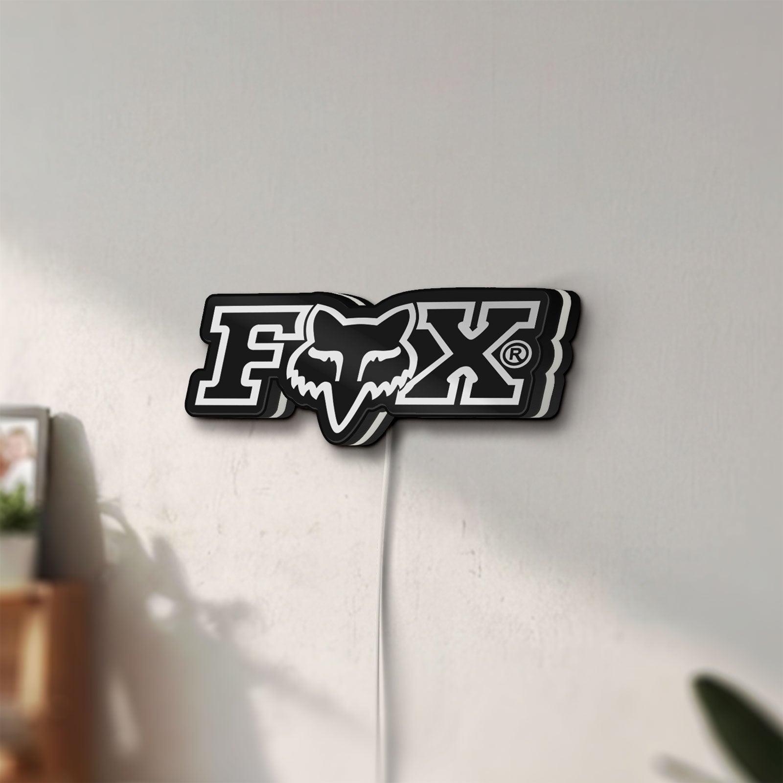 Unlit Fox Logo LED lightbox mounted on a wall in daylight