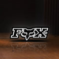 Front view of Fox Logo LED lightbox sign glowing on a wooden desk