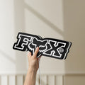 Unlit Fox Logo LED lightbox held by hand to show size and details