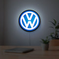 Volkswagen LED lightbox hanging on a room wall with soft blue light