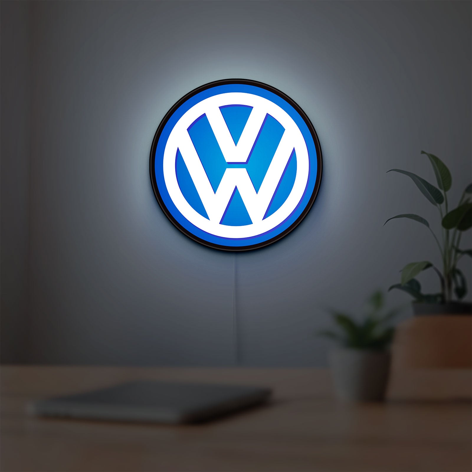Volkswagen LED lightbox hanging on a room wall with soft blue light
