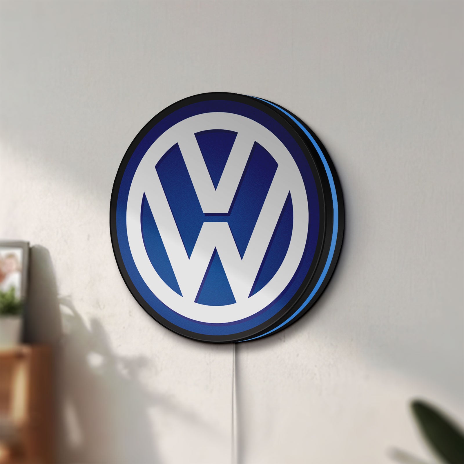Unlit Volkswagen LED lightbox mounted on a wall in daylight
