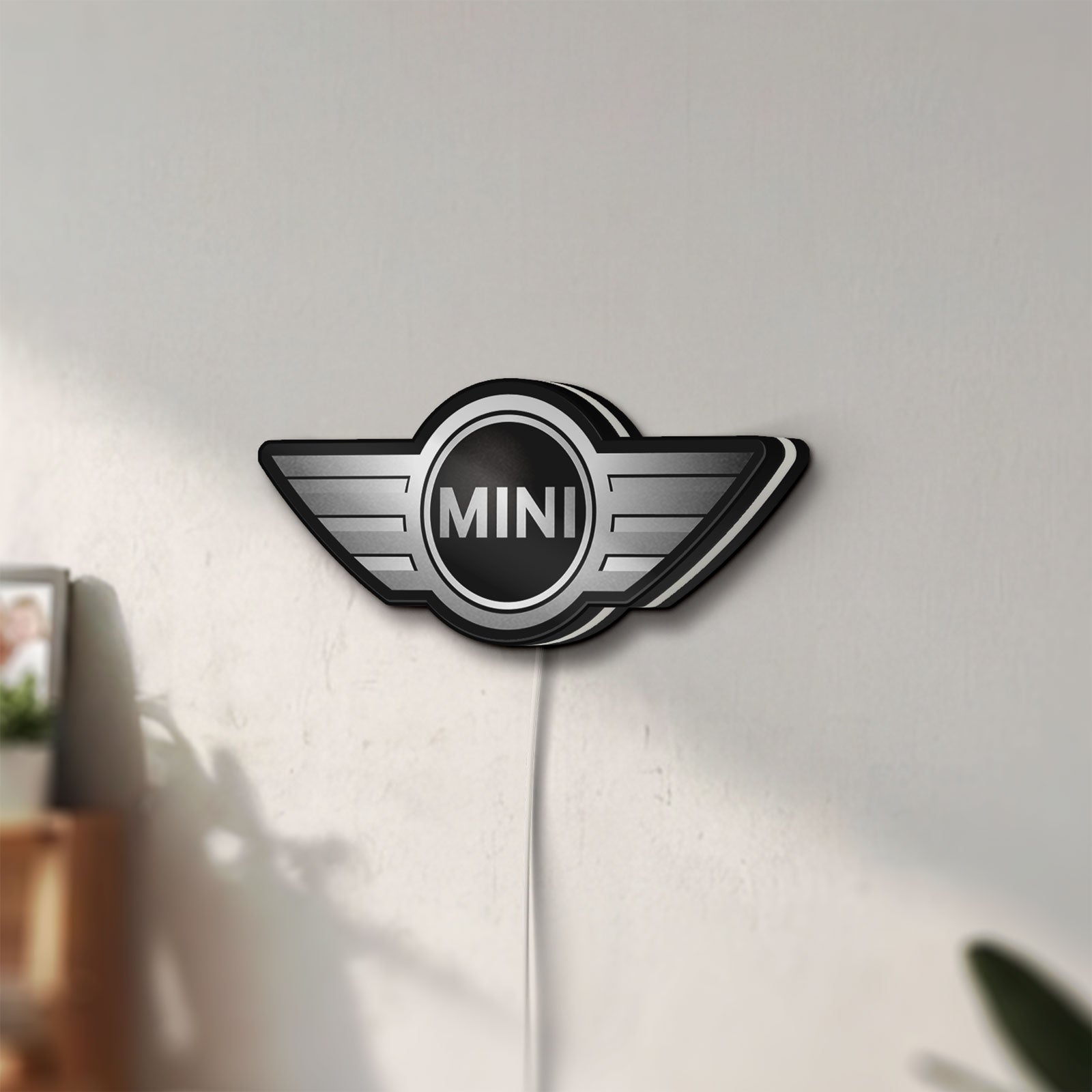 Unlit Mini Cooper LED lightbox mounted on a wall in daylight