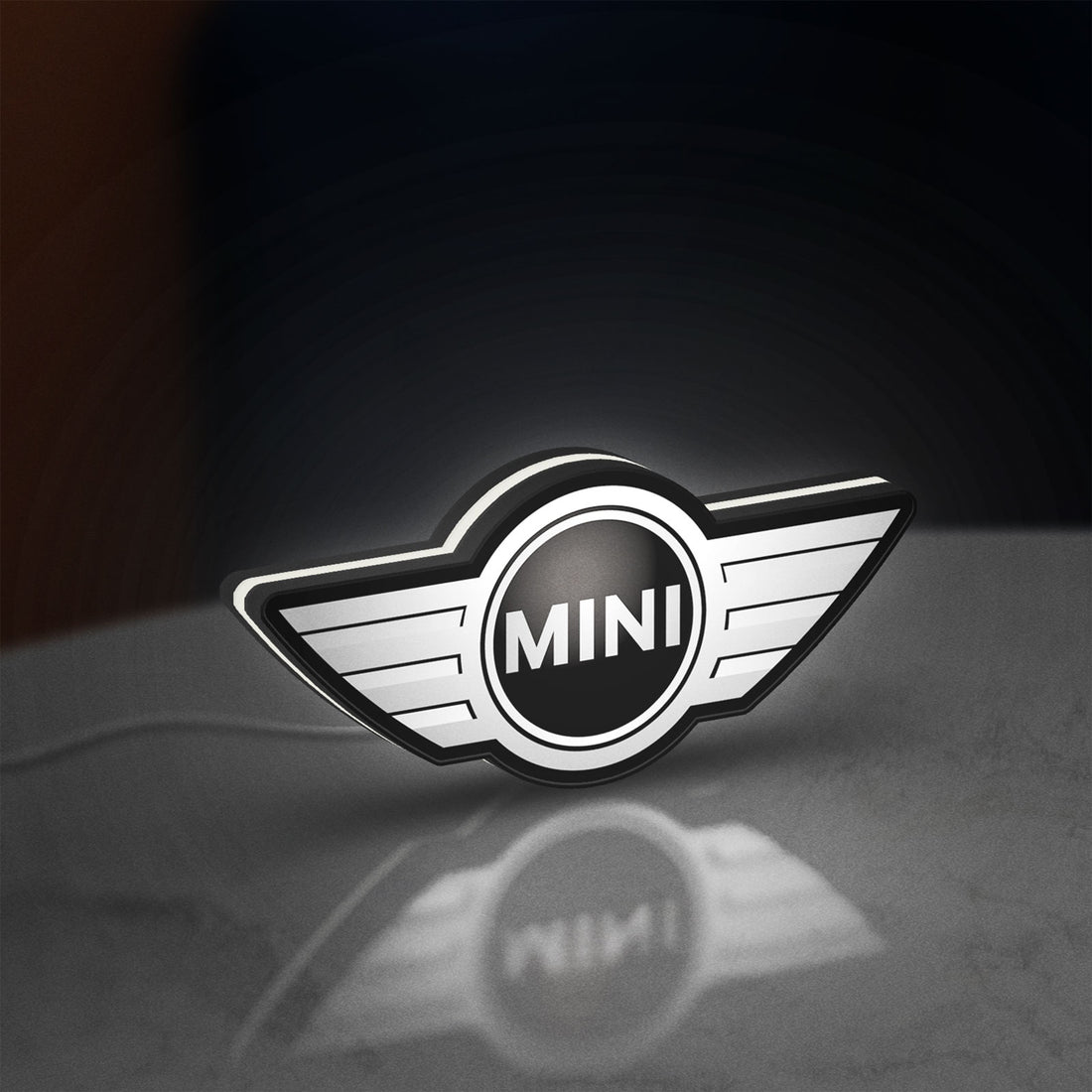 Mini Cooper LED lightbox hanging on a wall with white glow
