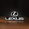 Front view of Lexus LED lightbox sign glowing on a wooden desk