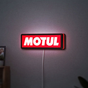Motul LED lightbox hanging on a wall with red glow