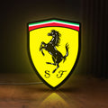 Front view of Ferrari GES LED lightbox sign glowing on a wooden desk