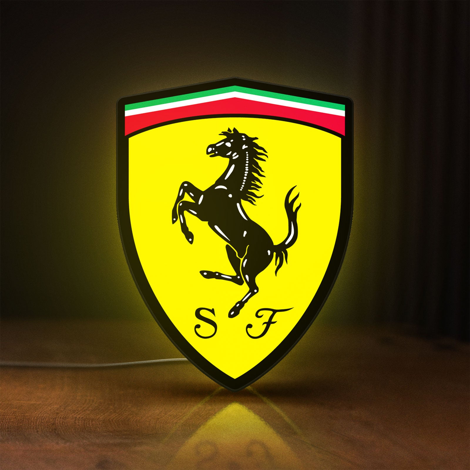 Front view of Ferrari GES LED lightbox sign glowing on a wooden desk
