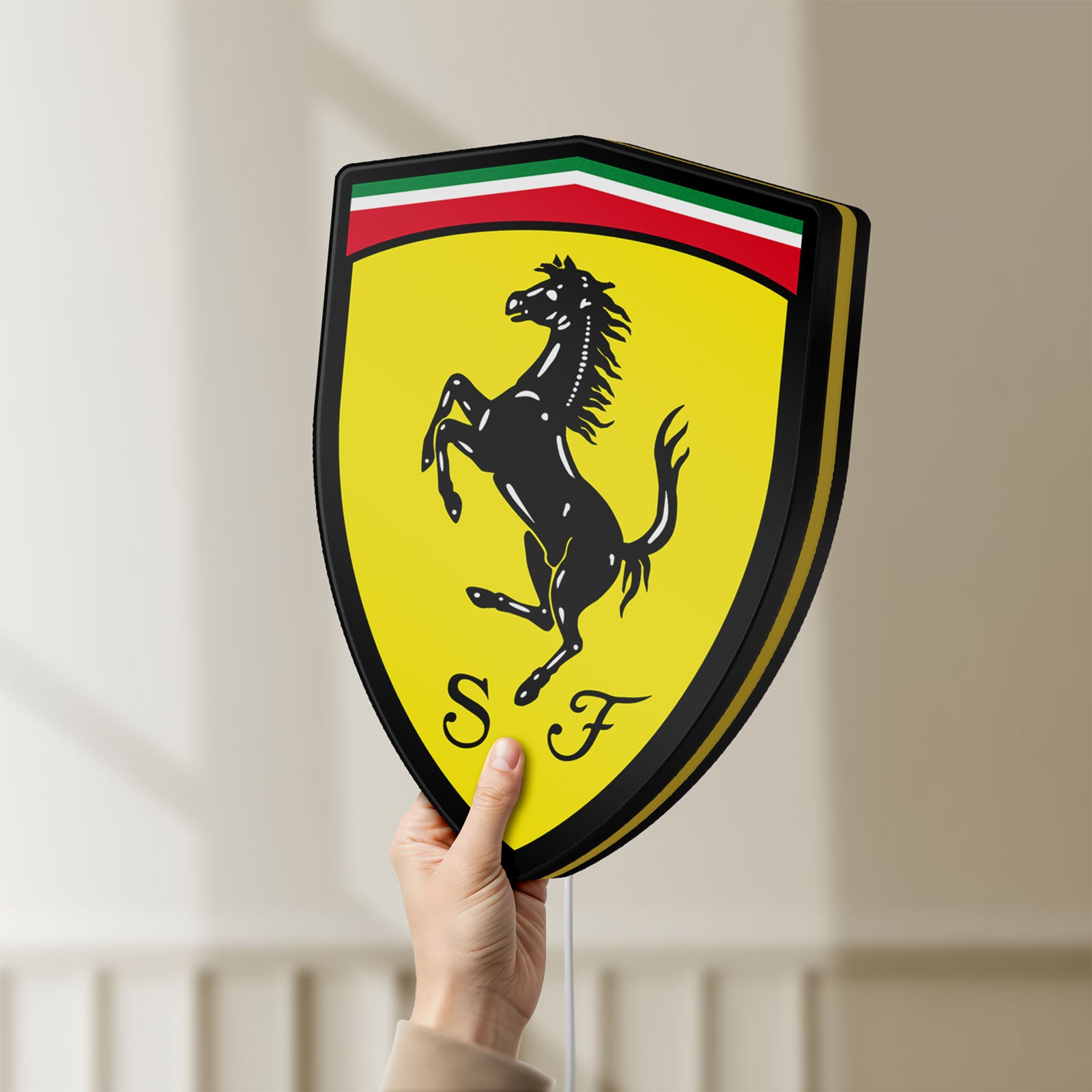 Unlit Ferrari GES LED lightbox held by hand to show size and details