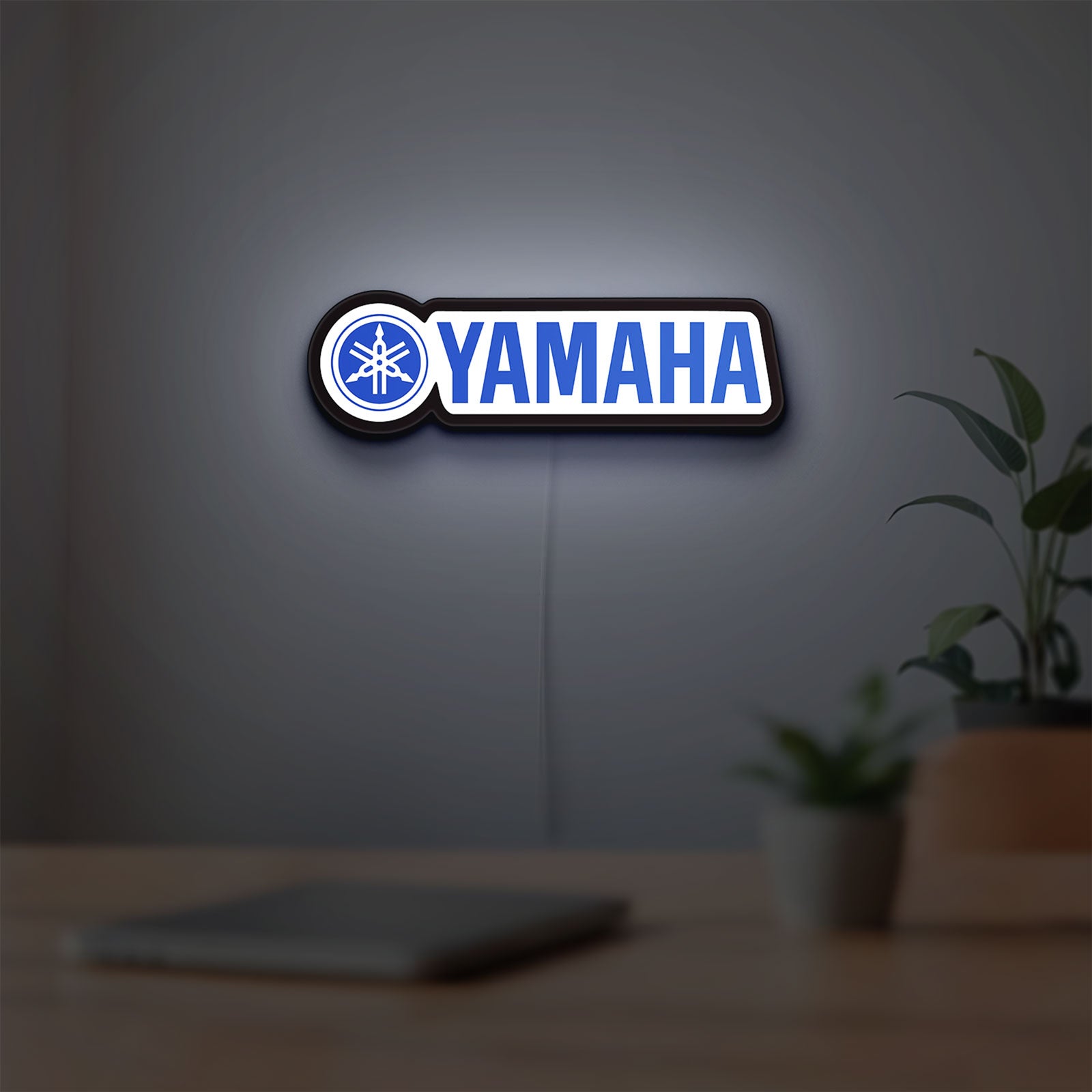 Yamaha LED lightbox hanging on a room wall with soft blue light