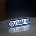 Yamaha LED lightbox standing on a desk from an angled side view with blue glow