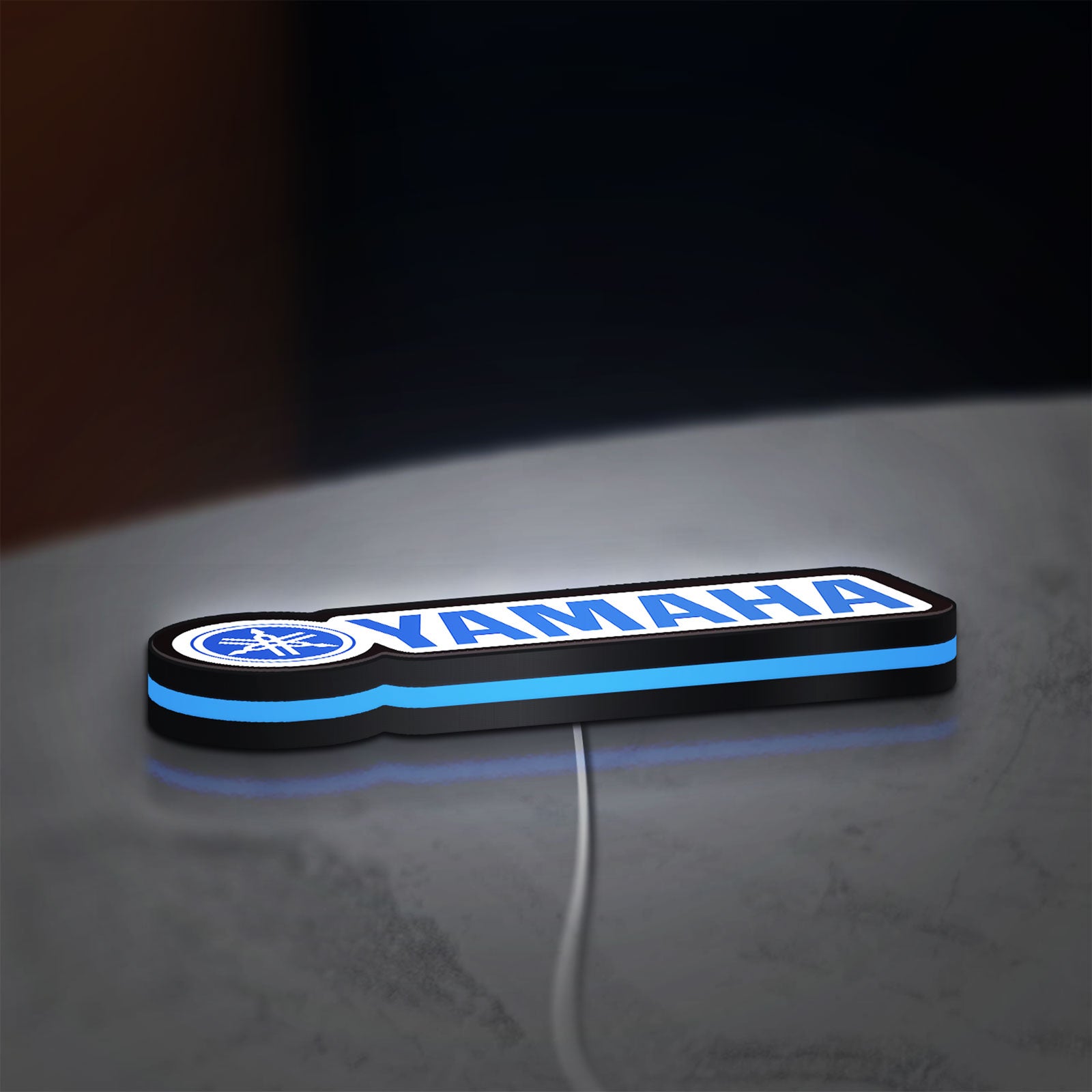 Yamaha LED lightbox lying flat on a desk with blue glow