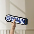 Unlit Yamaha LED lightbox held by hand to show size and details