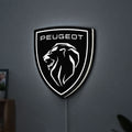 Peugeot Lion Head LED lightbox hanging on a wall with white glow