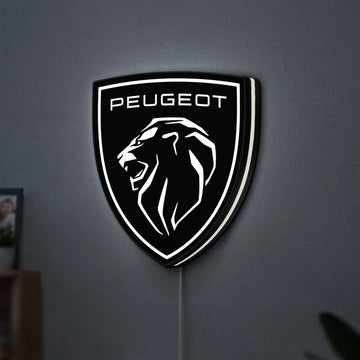 Peugeot Lion Head LED lightbox hanging on a wall with white glow