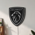 Unlit Peugeot Lion Head LED lightbox mounted on a wall in daylight