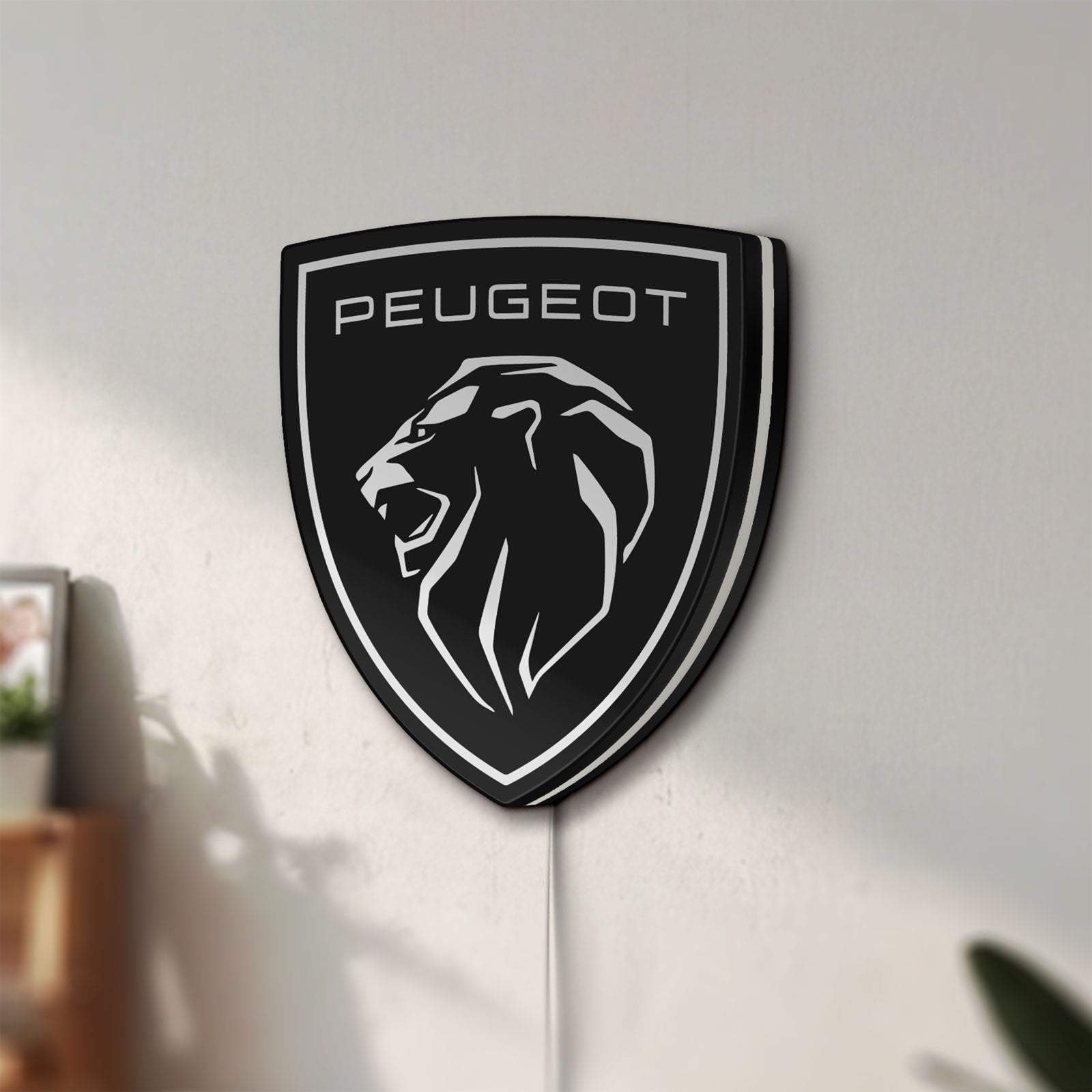 Unlit Peugeot Lion Head LED lightbox mounted on a wall in daylight