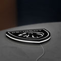 Peugeot Lion Head LED lightbox lying flat on a desk with white glow