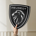 Unlit Peugeot Lion Head LED lightbox held by hand to show size and details