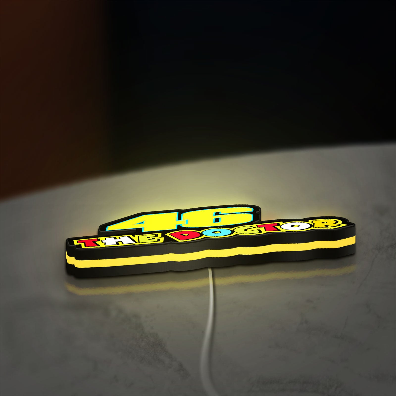 46 The Doctor LED lightbox lying flat on a desk with yellow glow